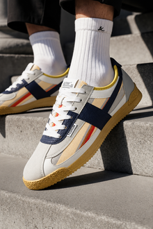 London Heritage Trainers Navy Yellow lifestyle angle on concrete steps